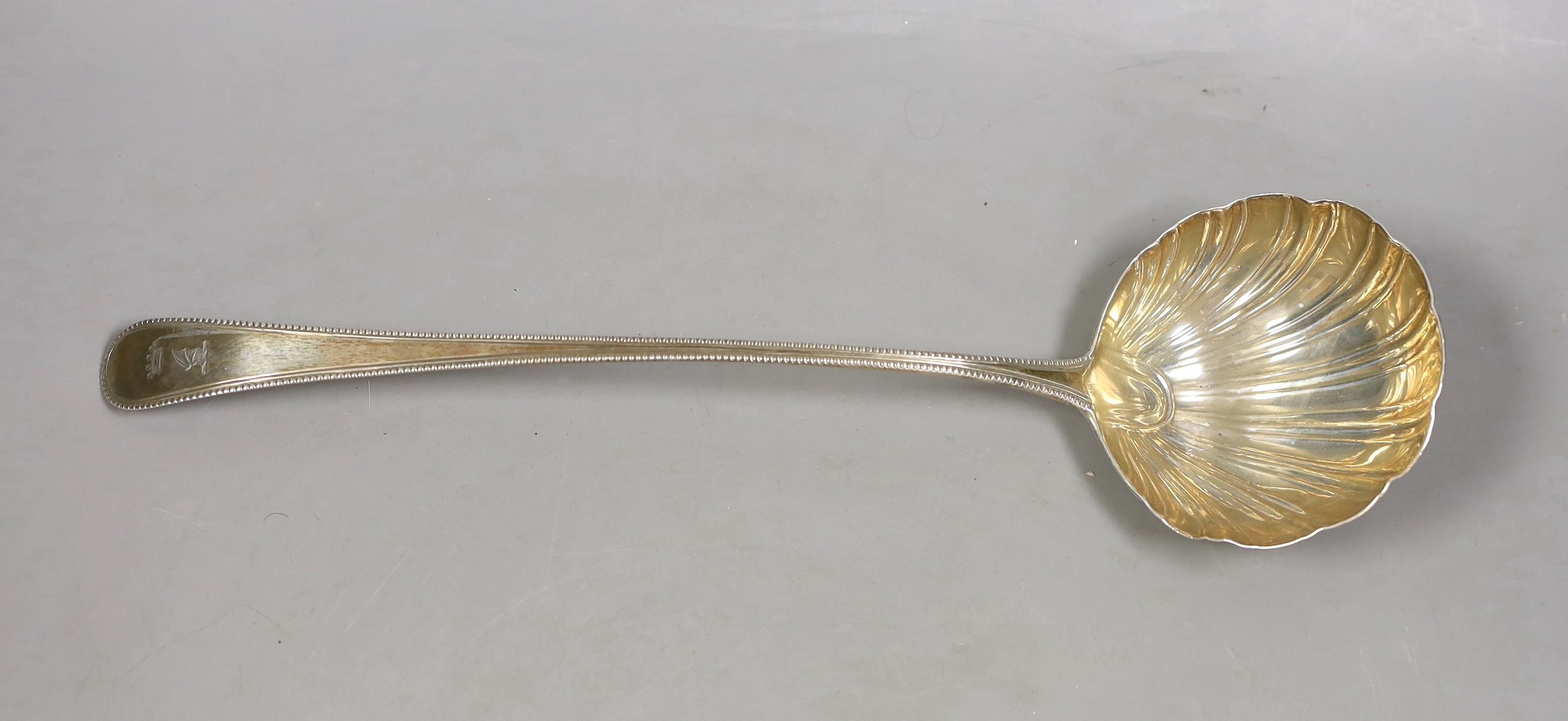 A George III silver Old English beaded pattern soup ladle, William Turton?, London, 1771, 33cm, with shell bowl, 127 grams.